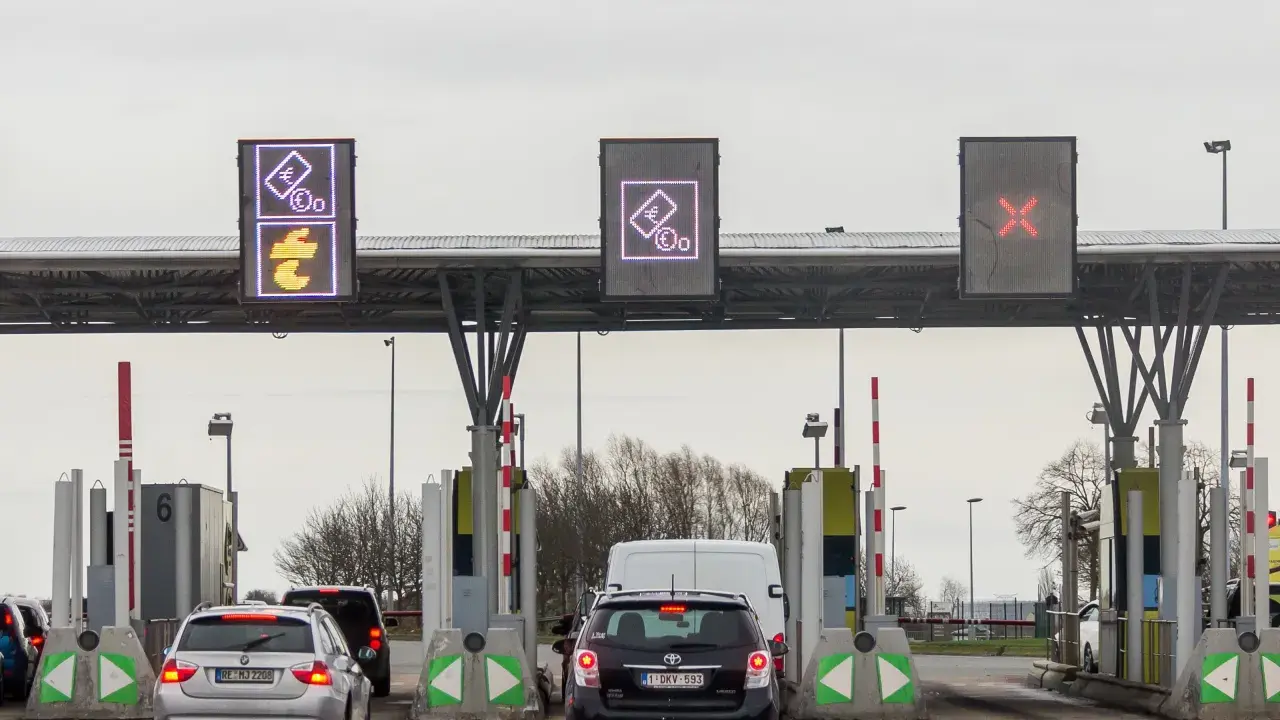 Korki na bramkach na autostradzie. Znaki pokazują symbole euro i przekreślone na czerwono pole.