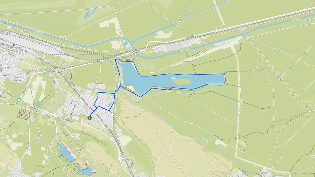 Mapa pokazuje trasę spacerową wokół jeziora w Jaworznie, z zaznaczonymi ulicami i terenami zielonymi.
