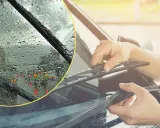 Deszcz na szybie i ręce wymieniające wycieraczki. Upewnij się, że masz płyn, by uniknąć mandatu za brak płynu do spryskiwaczy.