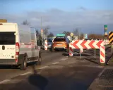 Korki na trasie do Władysławowa. Pomarańczowy SUV i biały bus stoją w kolejce za barierami drogowymi.