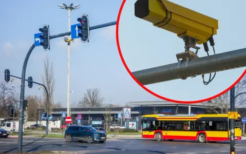 Żółte kamery na skrzyżowaniach rejestrują wykroczenia. Na zdjęciu widać skrzyżowanie z sygnalizacją świetlną, samochody i autobus.